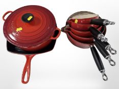 A graduated set of five Le Creuset enamelled cast-iron saucepans, largest 37cm long,