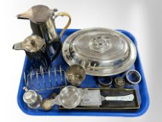 A silver plated lidded entree dish, two jugs, toast rack, stamp box, napkin rings,