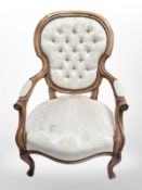A reproduction continental style carved salon armchair