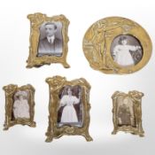 Five brass Art Nouveau picture frames, largest 16cm diameter.