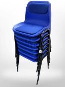 Seven plastic stackable chairs