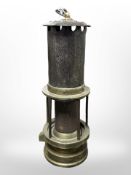 A 19th-century J Mills of Newcastle brass and steel miner's safety lamp with central gauze shield.