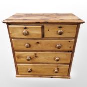 A contemporary pine five drawer chest,
