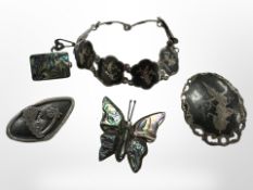 A collection of silver, niello and mother of pearl jewellery.