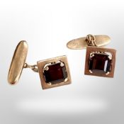 A pair of 14ct gold cufflinks set with garnets CONDITION REPORT: 7.