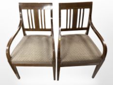 A pair of 19th-century continental mahogany and satinwood-inlaid armchairs.