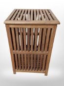 A Scandinavian teak lattice laundry hamper,