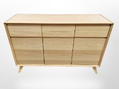 A contemporary oak effect sideboard,