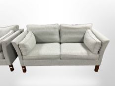 A late 20th century Danish two-seater settee in pale blue fabric,