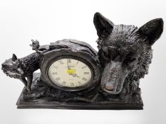 A Juliana bronze-effect quartz mantel timepiece surmounted by wolves, width 43cm.