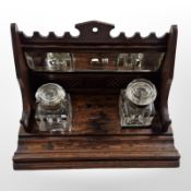 A Victorian oak desk stand with two ink wells,
