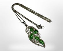 A 9ct white gold jade and diamond pendant on 14ct gold chain.
