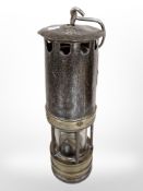 A 19th-century brass and steel Hailwood improved miner's lamp.