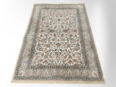 A machine-made rug of Persian design,