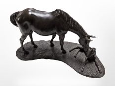 A bronze-effect resin sculpture of a horse and foal, width 36cm.