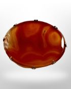 A gold mounted antique hardstone brooch, 4cm by 5cm.