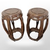 A pair of reproduction Chinese style hardwood barrel shaped plant stands,