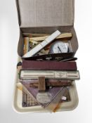 A group of slide rules, hydrometer, protractors, vintage paper guillotine, etc.