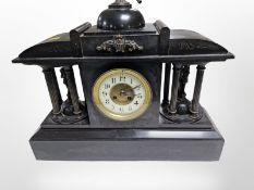 A Victorian black slate eight day mantel clock, striking on a gong, with pendulum and key,