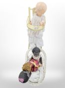 A wicker doll's hamper and dolls, together with a high chair.