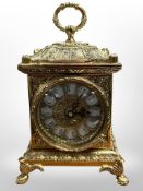 An ornate reproduction gilt-brass mantel timepiece with quartz movement, height 24cm.