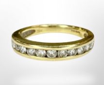 An 18ct gold diamond half eternity ring, size J½.