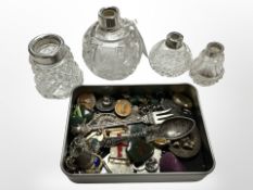 A tin containing badges, pins and hardstone pendants including jade and bloodstone,