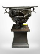 A cast-bronze urn on pedestal, height 21cm.