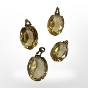 Four gold mounted citrines