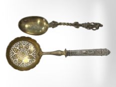A 19th century silver strainer and a mid-Victorian silver gilt spoon dated 1856 (2)
