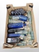 A quantity of clear and coloured glass bottles bearing advertising, Schweppes, Ridley,