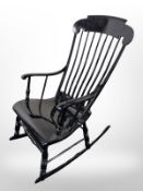 An ebonised rocking chair