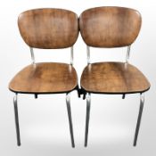 A pair of Scandinavian chrome dining chairs in brown vinyl upholstery
