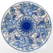 A Charlotte Rhead pottery charger with tube-lined decoration, diameter 32cm.