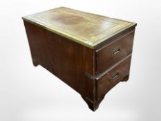 A mahogany two drawer low cabinet, with tooled leather inset top,