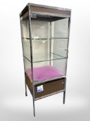 A chrome and glass illuminated display cabinet (continental plug),