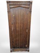 A 1920's carved oak single door hall cabinet,