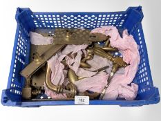 A crate of brass door plates and door handles