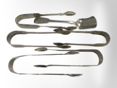 Five pairs of Georgian/William IV sugar tongs and a spoon,