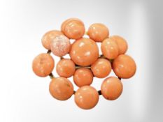 A gold mounted coral brooch