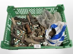 A crate of vintage wooden door handles and brass fittings