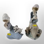 Two Lladró figure groups of girls with dogs.