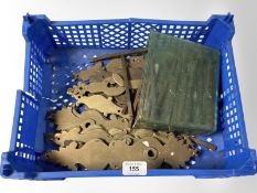 A crate of vintage brass door plates