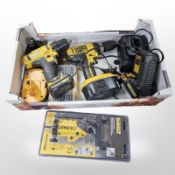 A group of Dewalt tools including two power drills with chargers,