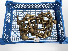 A crate of vintage brass door handles