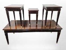 A continental mahogany coffee table on tapering brass capped legs,