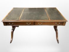 A reproduction mahogany library table in the Regency style with leather inset top,