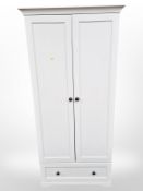 A contemporary white double wardrobe,