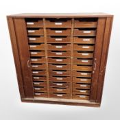 A 20th century Danish teak office sliding door index cabinet,