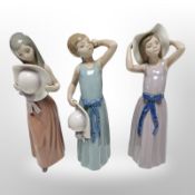 Three Lladró figures of girls in summer dresses, tallest 26cm.